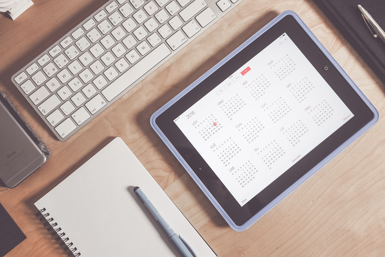 a calendar on a tablet that sits on a work desk
